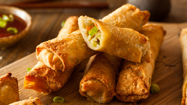 Pork egg roll on wooden cutting board 