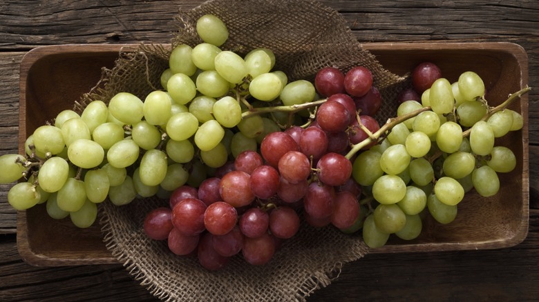 A Costco display with packages of green grapes