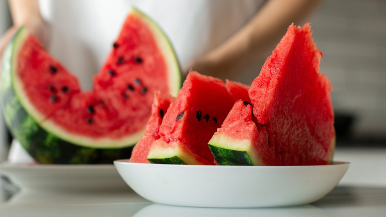 Sliced watermelons wedges with seeds.