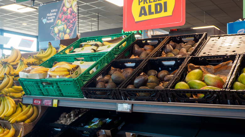 Produce section of an Aldi store in Italy with avocados and bananas