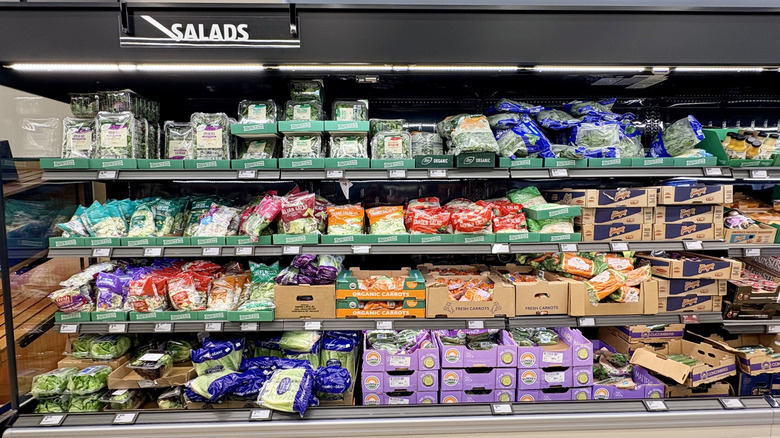 A display case of Aldi bagged salads