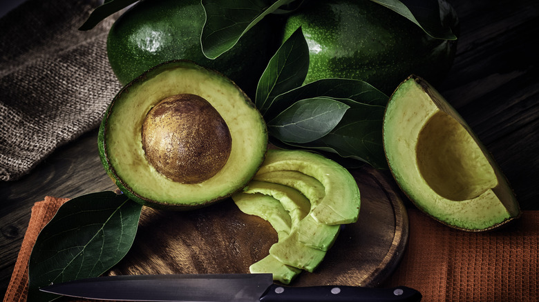 Sliced avocados on a cutting board.