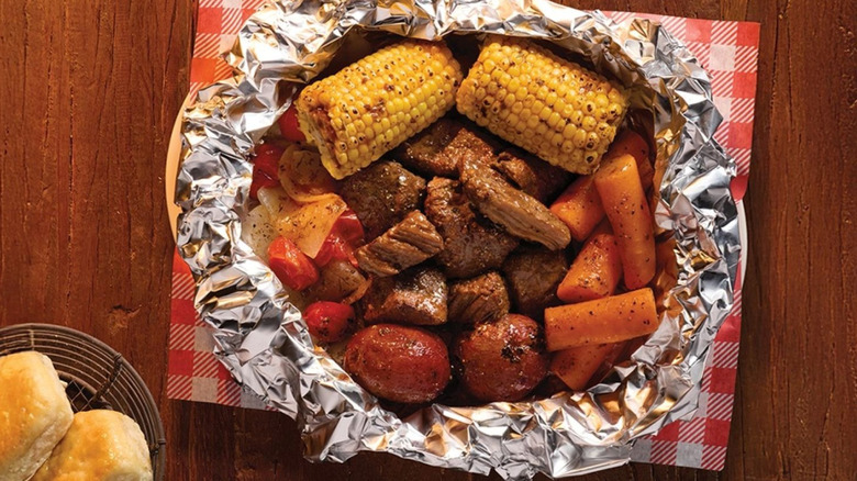 Cracker Barrel beef bowl with corn on the cob and carrots.