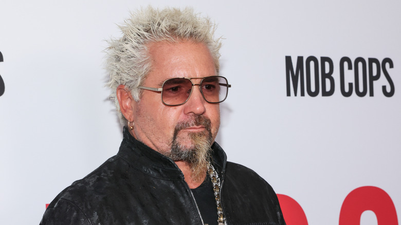 Guy Fieri poses for a photo at an event