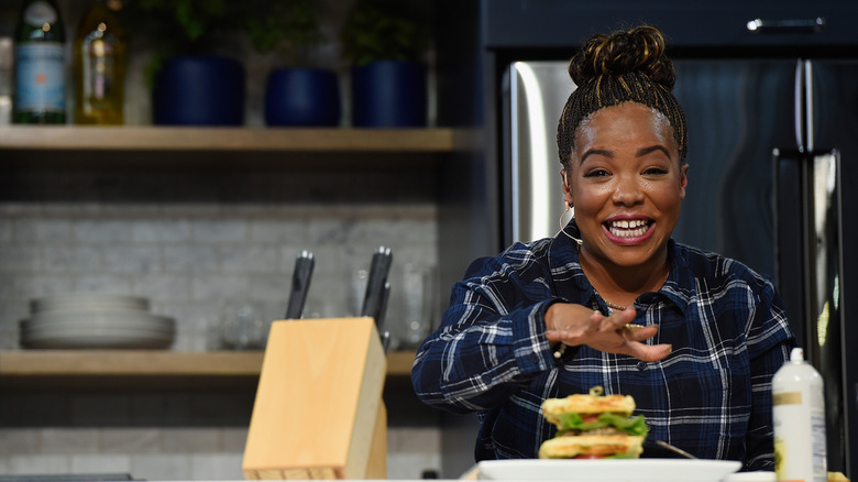 Tregaye Fraser smiles while cooking