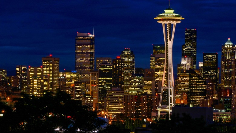 The Seattle skyline at night with the Space Needle visible.