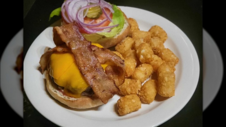 A bacon cheeseburger and tator tots at Jules Mae Saloon in Seattle.