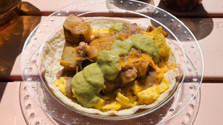 Breakfast taco with salsas in background at Tamale House East.