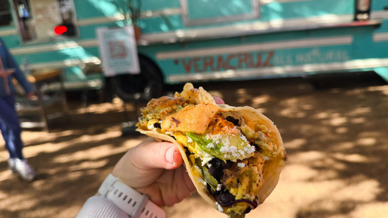 Migas poblanas breakfast tacos with Veracruz All Natural food truck in background.
