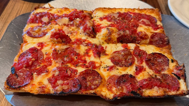 A Detroit-style pizza on a plate at Buddy's Pizza