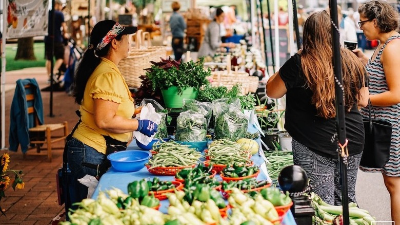A vendor selling vegetables at the Bentonville Farmer's Market in Bentonville