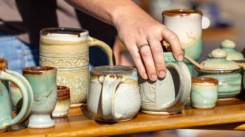 A person holding ceramics at the Farmers Market Ogden