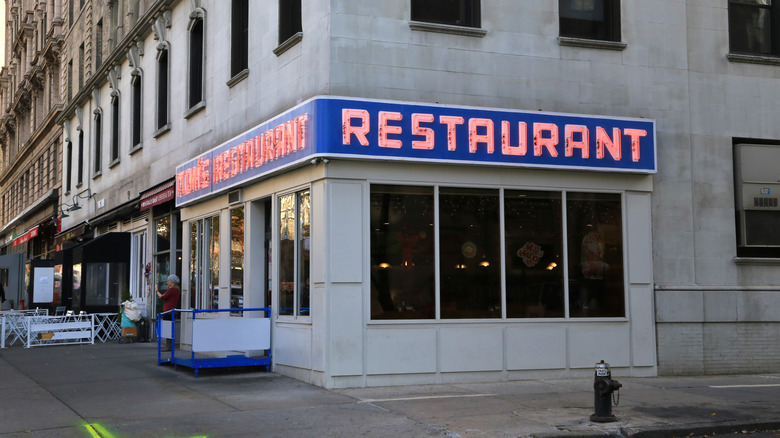 The exterior of Tom's Restaurant in NYC has a red neon letters on a blue background that appeared in Seinfeld