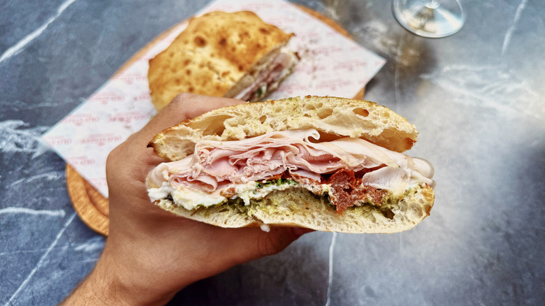 Hand holding a sandwich