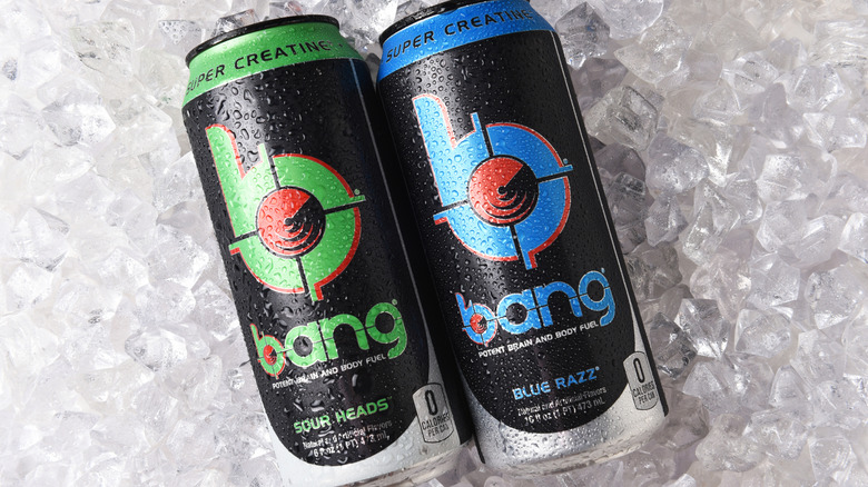 Two cans of Bang Energy on a background of ice cubes