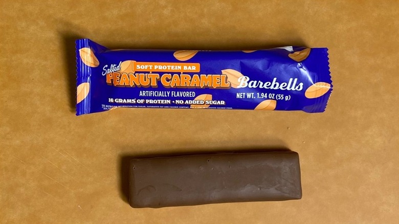 a Salted Peanut Caramel Barebells protein bar beside its packaging