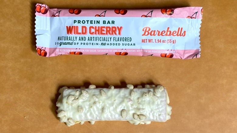 a Wild Cherry Barebells bar sitting alongside its packaging