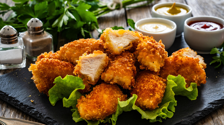 Fresh chicken nuggets with condiments