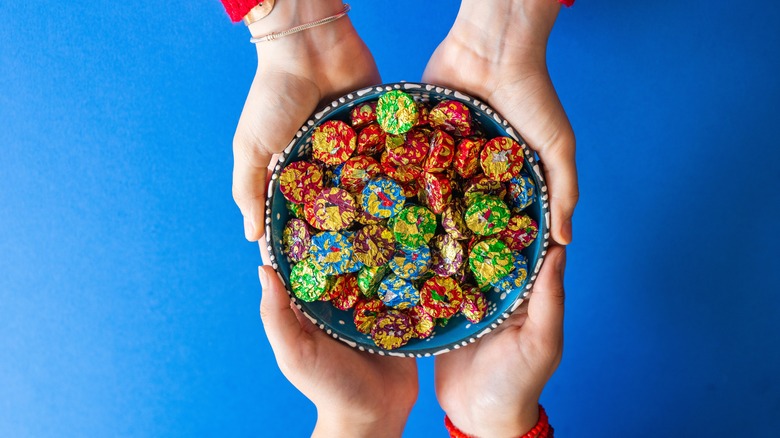 top down view of candy bowl held by two people