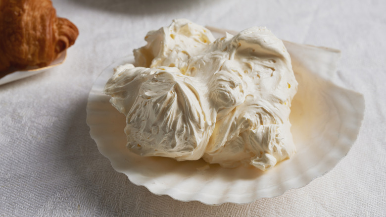 Whipped butter and croissant in the background