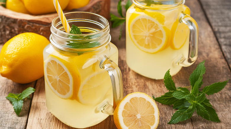 Mason jars of lemonade with lemons and mint