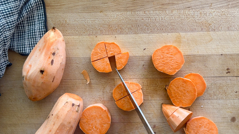knife cutting sweet potatoes