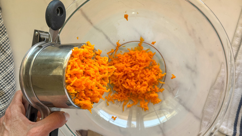 hand ricing the sweet potatoes