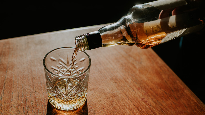 Pouring whiskey into glass