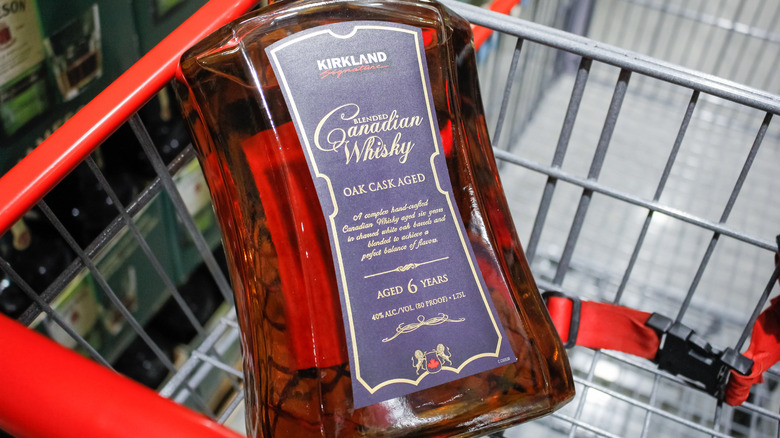 One bottle of Kirkland Signature Canadian Whisky in a grocery store cart