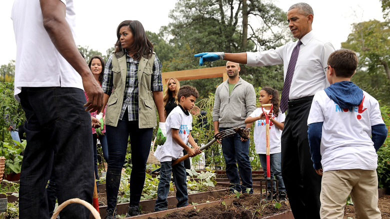 Barack and Michelle Obama working with kids in the White House Kitchen Garden