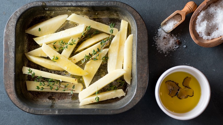 raw homemade french fries with herbs, salt, and black truffle oil