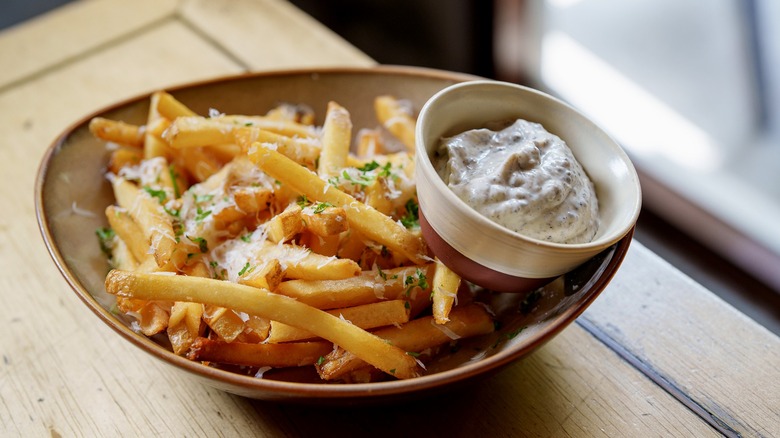french fries with truffle oil, parmesan cheese, parsley, and aioli