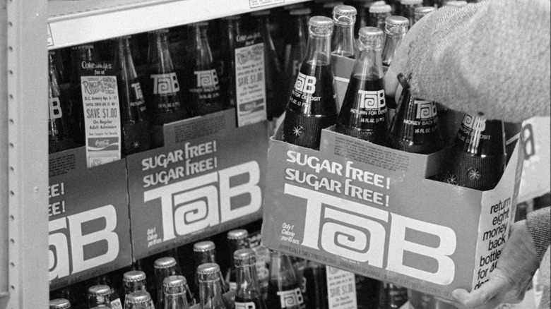 Vintage photograph of customer grabbing Tab soda