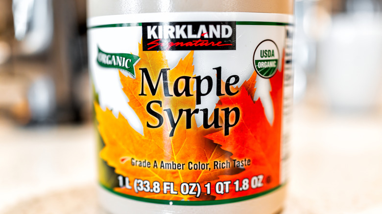 A bottle of Kirkland maple syrup from the front.