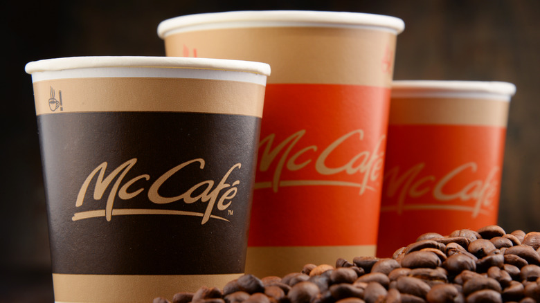 three McDonald's coffee cups with beans