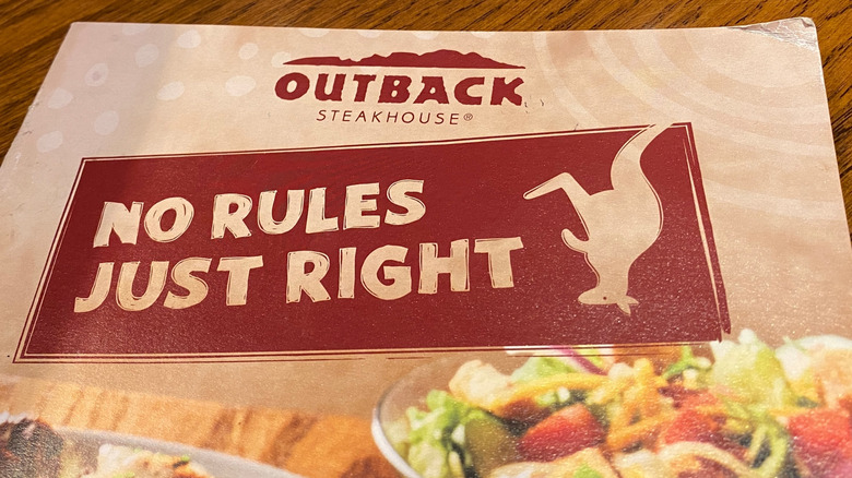 An Outback Steakhouse menu with the "No Rules, Just Right" slogan printed on it.
