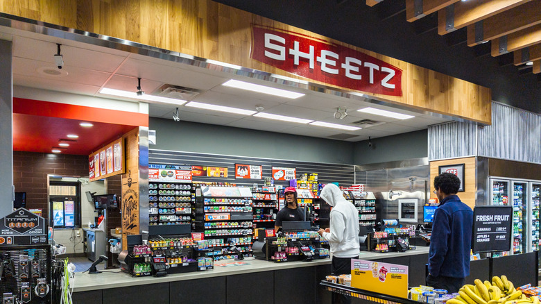 Interior of a Sheetz store with customers and employee behind the register