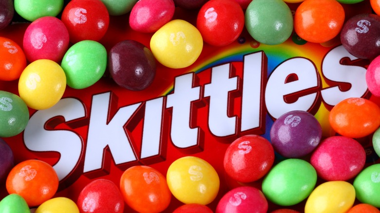 mixed skittles creatively framing the brand's logo