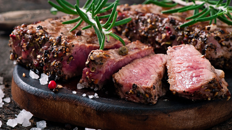 Medium rare steak on platter.