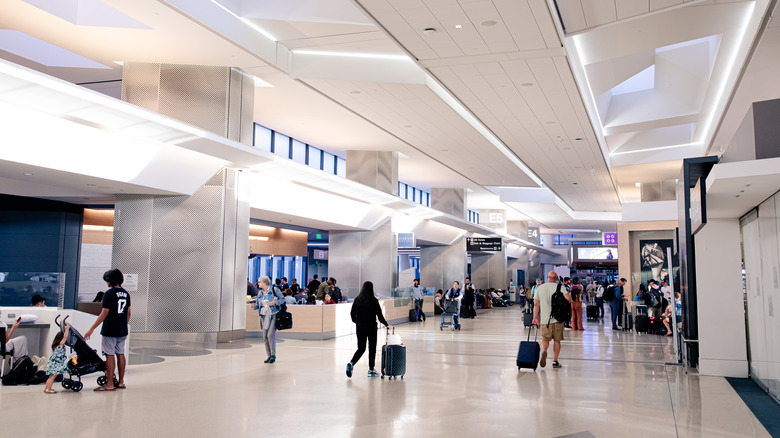 People walking through airport terminal