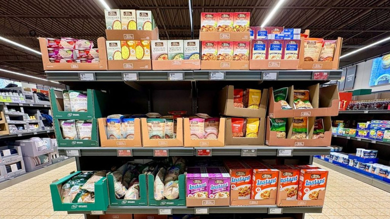 Products inside plain boxes on Aldi shelves.