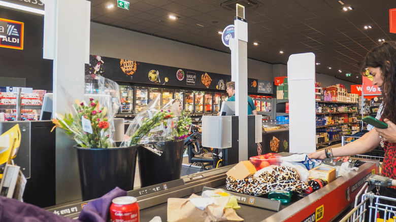 Woman checking out at Aldi