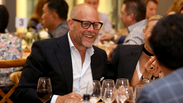 Alton Brown with smiling at a restaurant