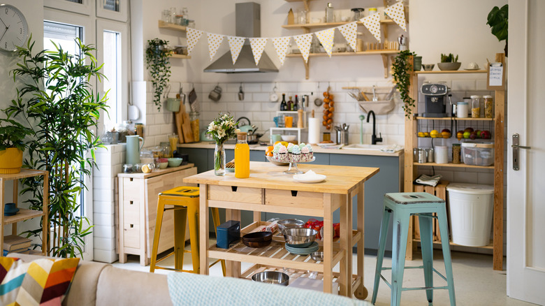 A kitchen scene with an island in the center.