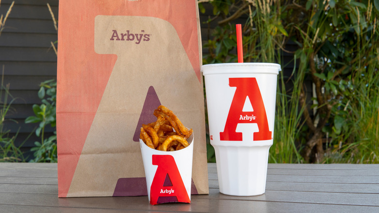 Arby's fries and drink next to paper bag