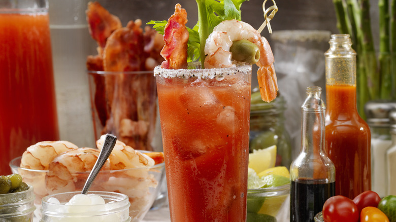 Bottle of hot sauce next to Bloody Mary cocktail