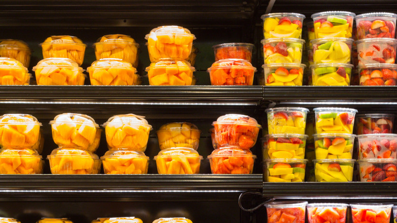Cut fruit in containers on a grocery store shelf