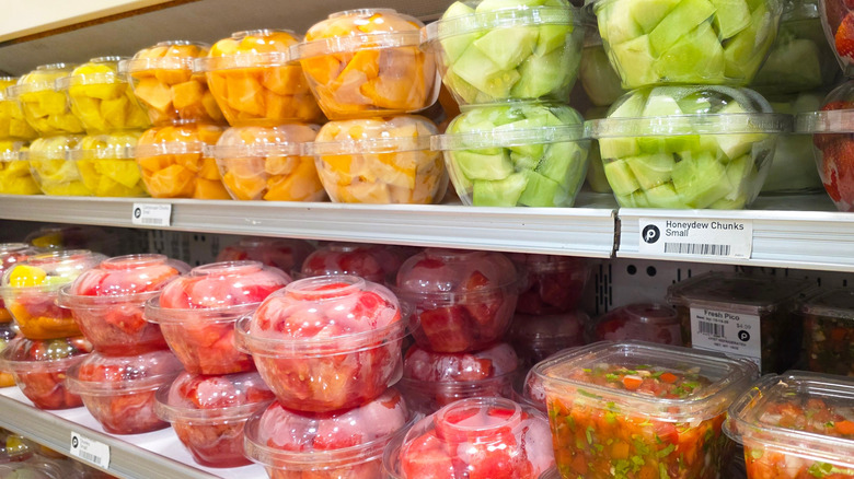 Cut fruit in containers on a grocery store shelf