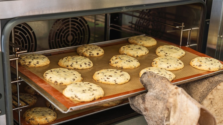 cookies on middle rack in oven being moved