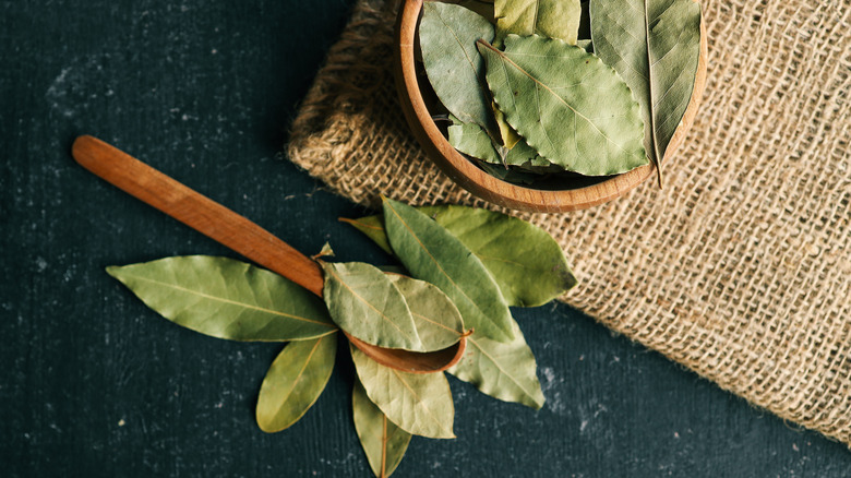 Dried bay leaves in a wooden bowl.